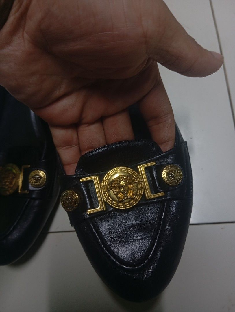 Gianni Versace Black Leather Loafers Size 37 (Category: Loafers) located in Calabanga. Submitted by younghustler. (Listing ID 1470104890, Image 3). Description: - Brand: Gianni Versace - Style: Black leather slip-on loafers with stacked heels - Size: 37 (Made in Italy) - Hardware: Iconic gold Medusa emblem - Soles: Textured soles with normal sign of wear on the bottom - Condition: Slight creasing on the leather upper, overall timeless designer pi