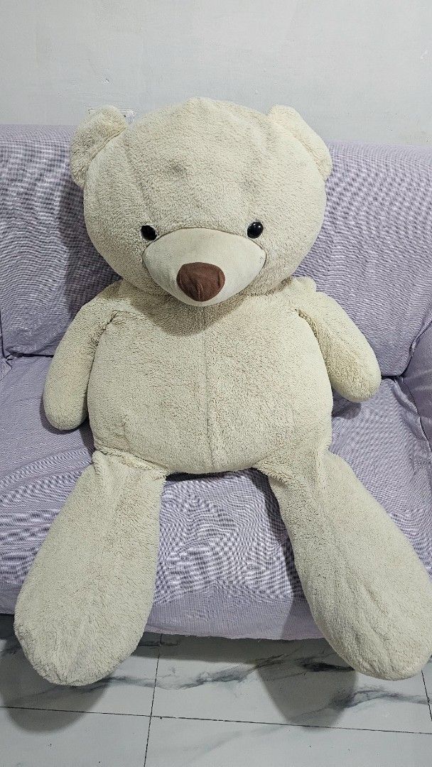 Giant beige stuffed teddy bear plush toy (Category: Plushies & Soft Toys) located in San Jose del Monte. Submitted by stellarbeauty (Listing ID 1469948416, Image 1). Description: - Size: Giant (takes up a whole couch) - Color: Cream with dark button eyes and brown snout - Material: Super fluffy and soft plush - Condition: Clean and well-maintained - Best for: Room decor or cuddling.