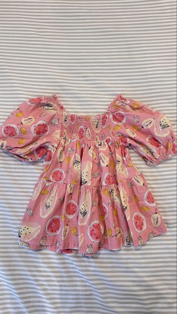 Gingersnaps Tiny Pink Fruit Print Blouse Size 6 (Category: Babies & Kids Fashion) located in General Trias. Submitted by dphazel (Listing ID 1470047798, Image 1). Description: - Brand: Gingersnaps (Tiny line) - Lightly used. Worn only 2x - Size: 6 (Best fit 4-9mos) - Color/Design: Pink with all-over watermelon and papaya fruit print - Details: Square neckline with smocked elastic chest, short puff sleeves with ruffled cuffs, and a layered ruffled