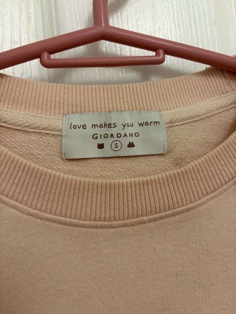 Giordano Pink Bear Print Sweatshirt Size S (Category: Coats, Jackets and Outerwear) located in Cabuyao City. Submitted by _camilleeee_ (Listing ID 1470052386, Image 2). Description: - Brand: Giordano - Color: Pastel pink - Size: Small (S) - Design: Cute bear graphic with 'a big warm hug' text and 'love makes you warm' branding - Details: Ribbed collar, cuffs, and hem - Material: Soft cotton blend - Condition: Excellent / Comfortable fit for casua