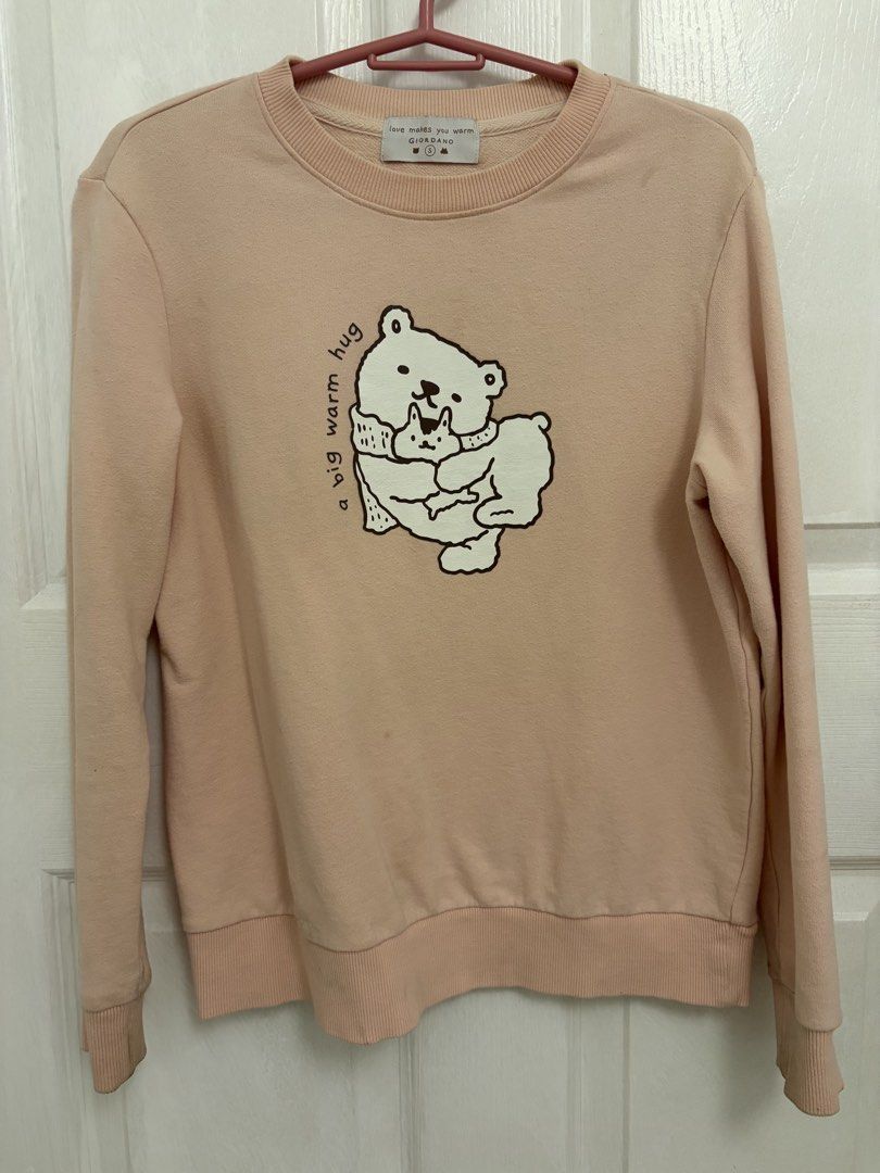 Giordano Pink Bear Print Sweatshirt Size S (Category: Coats, Jackets and Outerwear) located in Cabuyao City. Submitted by _camilleeee_ (Listing ID 1470052386, Image 1). Description: - Brand: Giordano - Color: Pastel pink - Size: Small (S) - Design: Cute bear graphic with 'a big warm hug' text and 'love makes you warm' branding - Details: Ribbed collar, cuffs, and hem - Material: Soft cotton blend - Condition: Excellent / Comfortable fit for casua