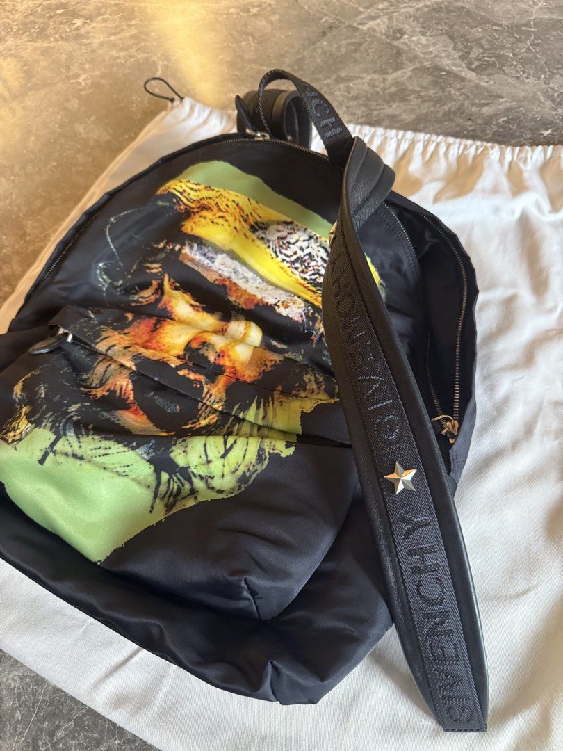 Givenchy Backpack (Category: Bags & Wallets) located in Singapore. Submitted by m31vyn (Listing ID 1470019935, Image 2). Description: Hey guys! Clearing out some space in my wardrobe and letting go of this super cool Givenchy backpack. It features an iconic graphic print on the front and comes with comfortable straps featuring the Givenchy branding and a star detail. The bag is made of durable nylon/fabric material with leather trim at the bottom