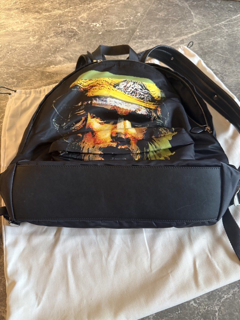 Givenchy Backpack (Category: Bags & Wallets) located in Singapore. Submitted by m31vyn (Listing ID 1470019935, Image 3). Description: Hey guys! Clearing out some space in my wardrobe and letting go of this super cool Givenchy backpack. It features an iconic graphic print on the front and comes with comfortable straps featuring the Givenchy branding and a star detail. The bag is made of durable nylon/fabric material with leather trim at the bottom