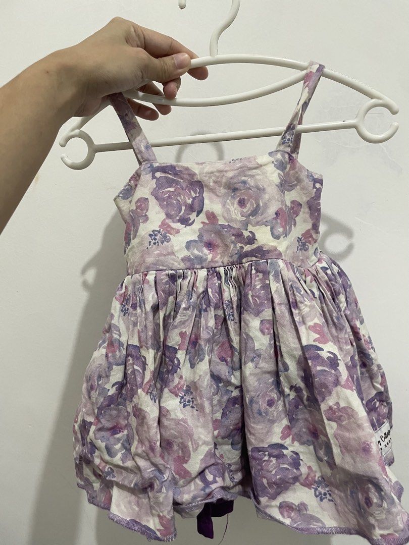 Glam stitches purple S1 (Category: Babies & Kids Fashion) located in Pila. Submitted by prelovedcams (Listing ID 1469951929, Image 1). Description: - Adorable purple and white floral print dress - Sleeveless design with delicate thin shoulder straps - Flattering gathered waistline with a playful bubble hem - Made from soft, lightweight, and comfortable fabric - Excellent clean condition, ready to wear for parties or casual outings.