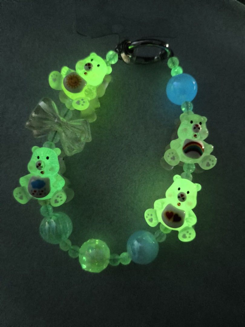 Glow in the dark Care Bear keychain beaded strap (Category: Character Goods) located in Caloocan City. Submitted by books_and_beads (Listing ID 1470091957, Image 3). Description: - Handmade beaded keychain featuring popular translucent Care Bear charms (Sunshine, Grumpy, Cheer, and Tenderheart) - Beautifully accented with pastel beads, iridescent round beads, and a clear bow charm - Special glow-in-the-dark feature: glows bright green after light