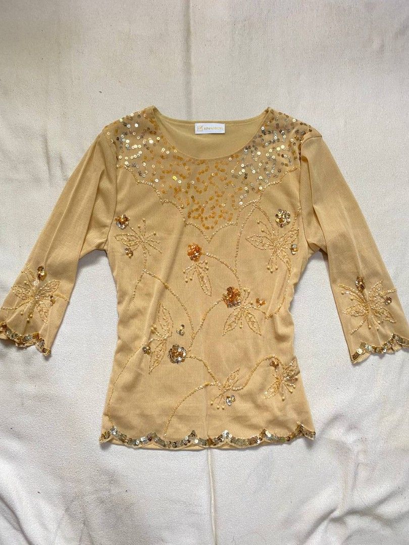 Gold Beaded Sequin Mesh Long Sleeve Blouse Top (Category: Blouses) located in Iloilo. Submitted by xya.xoxo28 (Listing ID 1470061780, Image 1). Description: - Gold sheer mesh top with delicate beadwork and sequin embroidery - Elegant floral vine patterns across the front and sleeves - Scalloped sequin hem at the bottom and cuffs - Round neckline with dense silver and gold sequins - Lightweight fabric with 3/4 sleeves - Condition: Excellent / Like