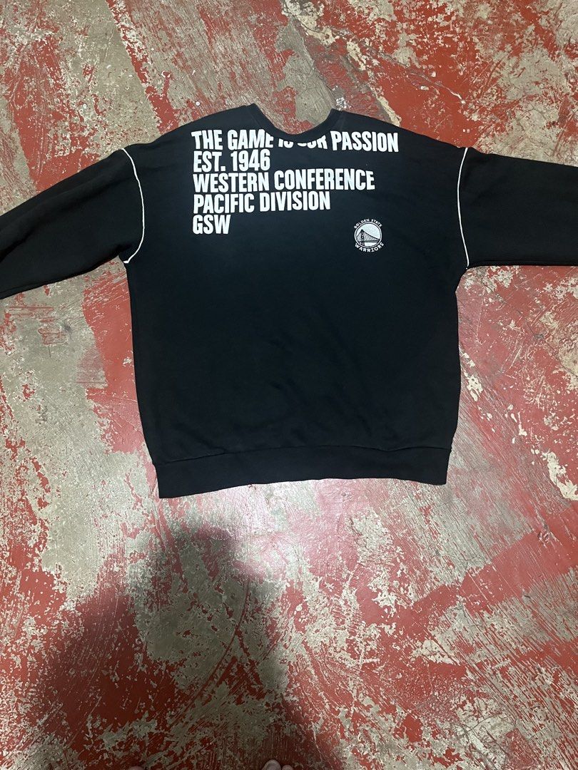 Golden State Warriors Black Sweatshirt (Category: Coats, Jackets and Outerwear) located in Manila. Submitted by cleverhorse.ab90fe (Listing ID 1469988612, Image 1). Description: - Color: Black with white lettering - Team: Golden State Warriors (Est. 1946, Western Conference Pacific Division logo) - Design: Bold WARRIORS front branding, sleeve piping, and "The Game Is Our Passion" back print - Details: Round neckline, ribbed cuffs and hem - Style:
