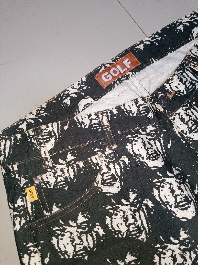 Golf Wang Face All Over Print Jeans (Category: Jeans) located in Manila. Submitted by mjthrifted_second (Listing ID 1469988225, Image 3). Description: - Brand: Golf Wang -Actual Size: 34/39 - Style: Straight leg denim pants with all-over face graphic print - Color: Classic black and white with contrast stitching - Details: Brown leather logo patch at back waistband, small yellow logo tag on front coin pocket, and branded metal button closure - Co