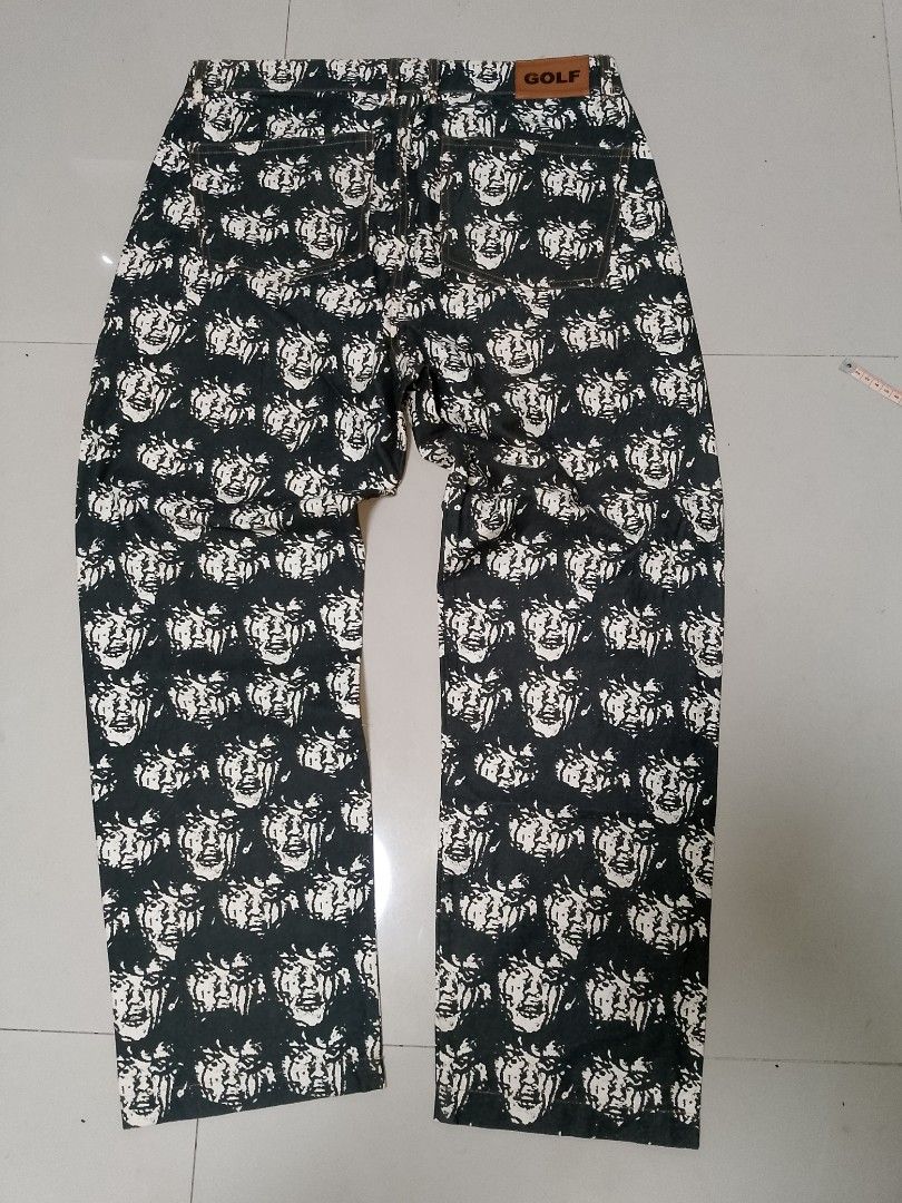 Golf Wang Face All Over Print Jeans (Category: Jeans) located in Manila. Submitted by mjthrifted_second (Listing ID 1469988225, Image 2). Description: - Brand: Golf Wang -Actual Size: 34/39 - Style: Straight leg denim pants with all-over face graphic print - Color: Classic black and white with contrast stitching - Details: Brown leather logo patch at back waistband, small yellow logo tag on front coin pocket, and branded metal button closure - Co