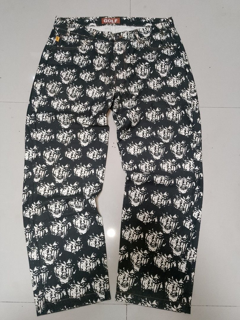 Golf Wang Face All Over Print Jeans (Category: Jeans) located in Manila. Submitted by mjthrifted_second (Listing ID 1469988225, Image 1). Description: - Brand: Golf Wang -Actual Size: 34/39 - Style: Straight leg denim pants with all-over face graphic print - Color: Classic black and white with contrast stitching - Details: Brown leather logo patch at back waistband, small yellow logo tag on front coin pocket, and branded metal button closure - Co