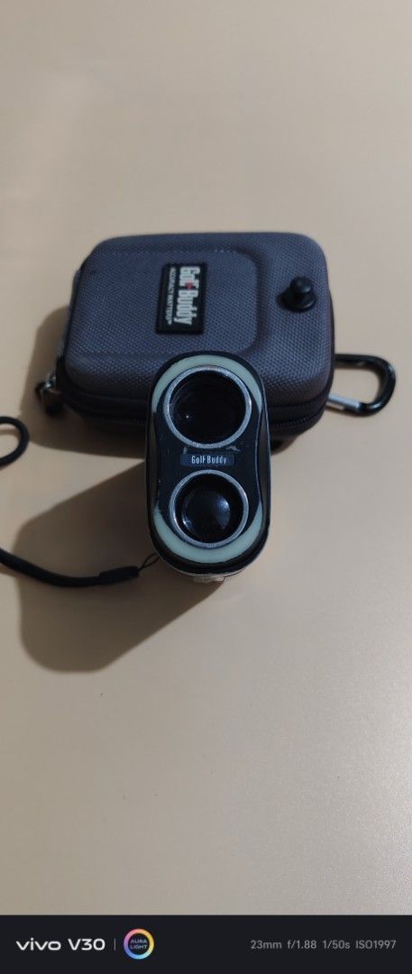 GolfBuddy LR7 Laser Rangefinder with Case (Category: Golf) located in Manila. Submitted by roblazo25 (Listing ID 1469973857, Image 2). Description: - Model: GolfBuddy LR7 laser rangefinder - Color: Sleek white and black - Performance: Measures distances accurately on the course - Portability: Compact size that easily fits in a pocket or bag - Extras: Includes original grey protective carrying case with carabiner clip and attached strap - Conditio