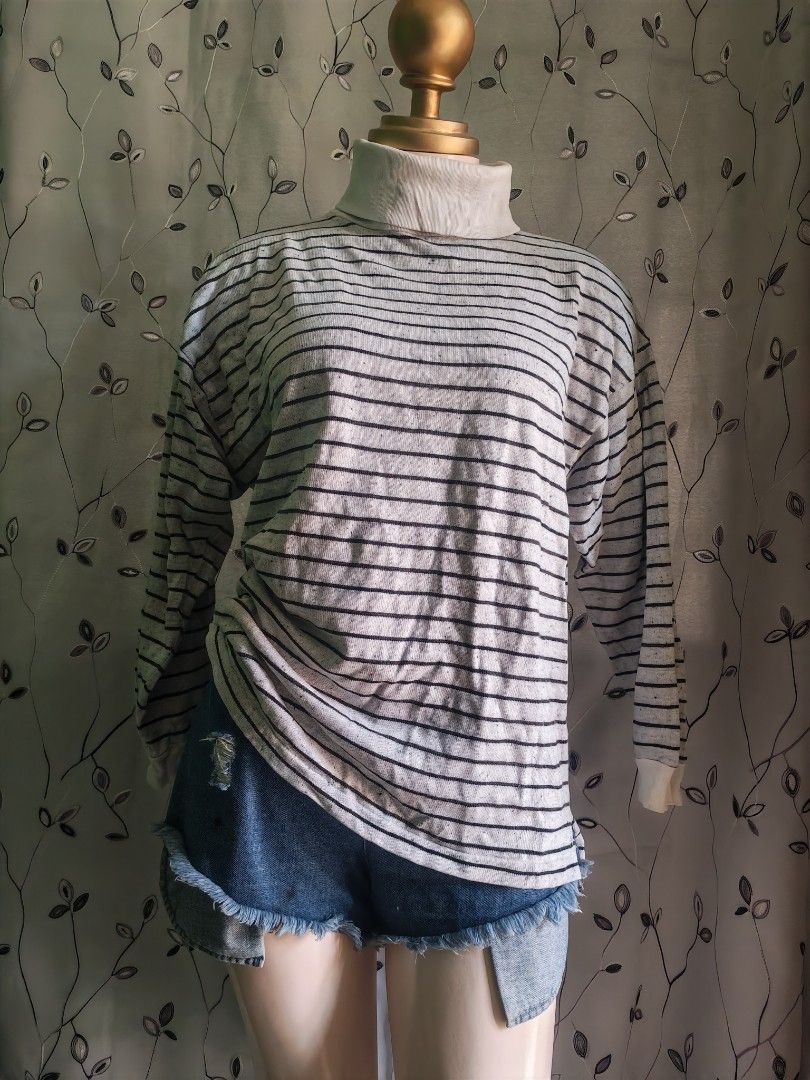 Goouch striped turtleneck long sleeve sweater (Category: Longsleeves) located in Caloocan City. Submitted by _misskaye (Listing ID 1470042473, Image 2). Description: - Brand: Goouch - Style: Vintage turtleneck sweater with horizontal stripes - Color: Cream base with thin black stripes - Size: Small (tag on collar) - Material: Warm and comfortable cotton blend - Features: Long sleeves, ribbed high neck - Condition/Use: Great piece for layering dur