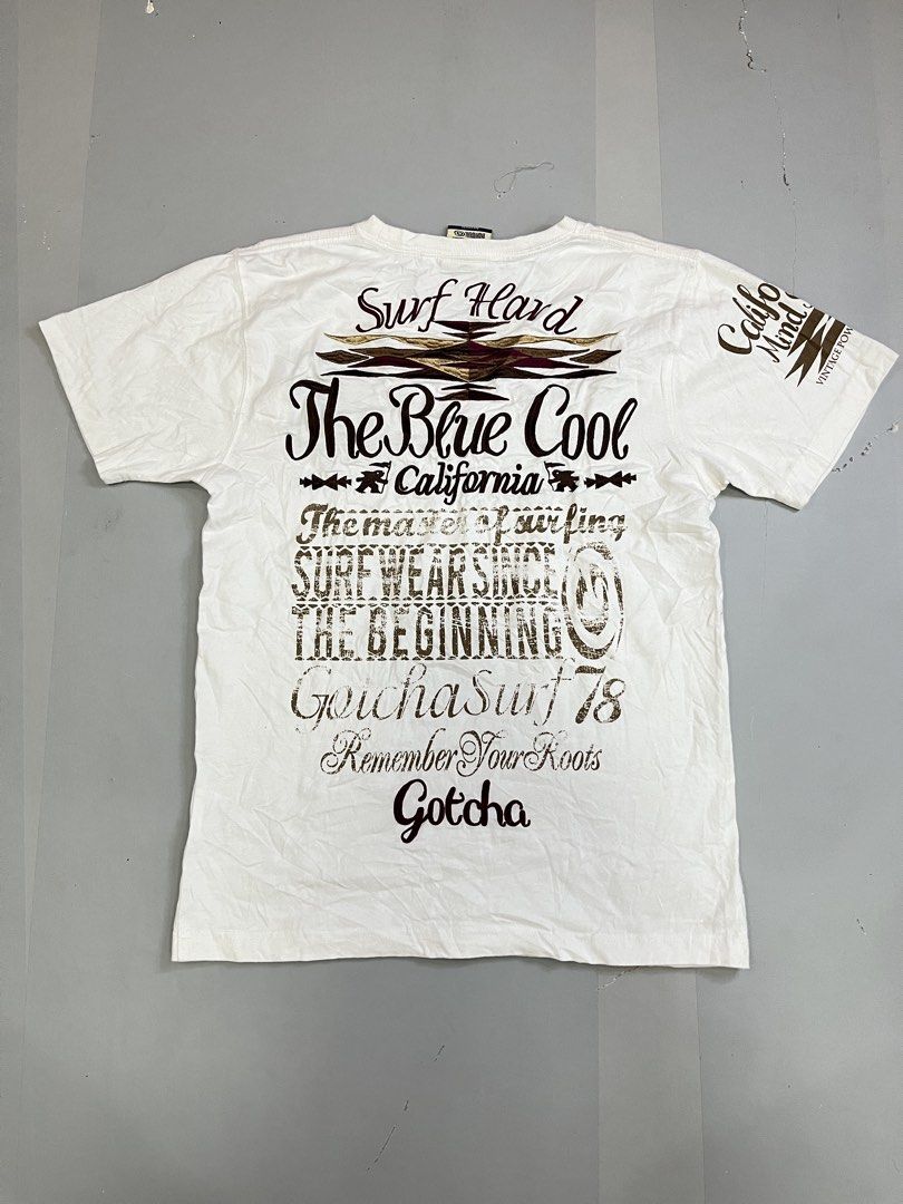 Gotcha Surf White Graphic T-Shirt (Category: Tshirts & Polo Shirts ) located in Mabalacat. Submitted by aas_thriftfings (Listing ID 1470130665, Image 2). Description: - Brand: Gotca - Color: White with brown and burgundy prints - Design: Surf graphics on chest, back, and sleeves with a woven logo patch near the hem - Fit: Regular fit, crew neck - Style: Casual everyday wear - Condition: Brand new / Excellent.