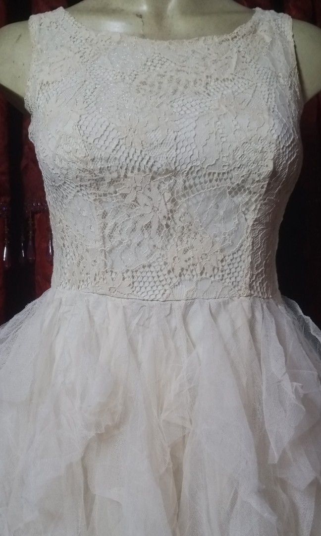 Gown (Category: Evening dresses & gowns) located in Manila. Submitted by wheneity67thifted (Listing ID 1470136928, Image 3). Description: This image shows an ivory-colored sleeveless dress featuring a detailed lace bodice and a cascading asymmetric tiered tulle skirt..