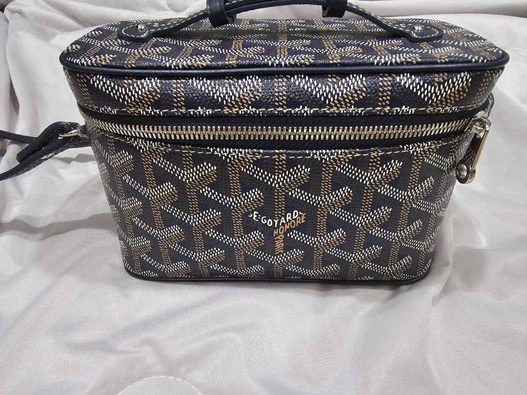 Goyard Mini Muse (Category: Luxury Bags & Wallets) located in Makati City. Submitted by stephanie48_whale (Listing ID 1470126824, Image 1). Description: Moving back sales , no dust bag , no cert , AUTHENTIC NO FAKE , slightly nego for serious buyer - Brand: Goyard Vanity Bag - Color: Classic Navy Blue with signature chevron print - Design: Structured boxy shape with silver-tone hardware and wraparound zipper - Versatility: Includes a top handle a