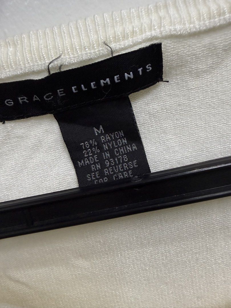 Grace Elements White Short Sleeve Knit Cardigan Size M (Category: Blouses) located in Quezon City. Submitted by reivia.vend (Listing ID 1469998848, Image 2). Description: - Brand: Grace Elements - Color: Classic White - Size: M (78% Rayon, 22% Nylon) - Style: Short-sleeve knit cardigan with a round neckline - Details: Elegant gold-toned front buttons, ribbed hem and sleeve cuffs - Condition: Excellent, great for everyday layering or smart-casual 