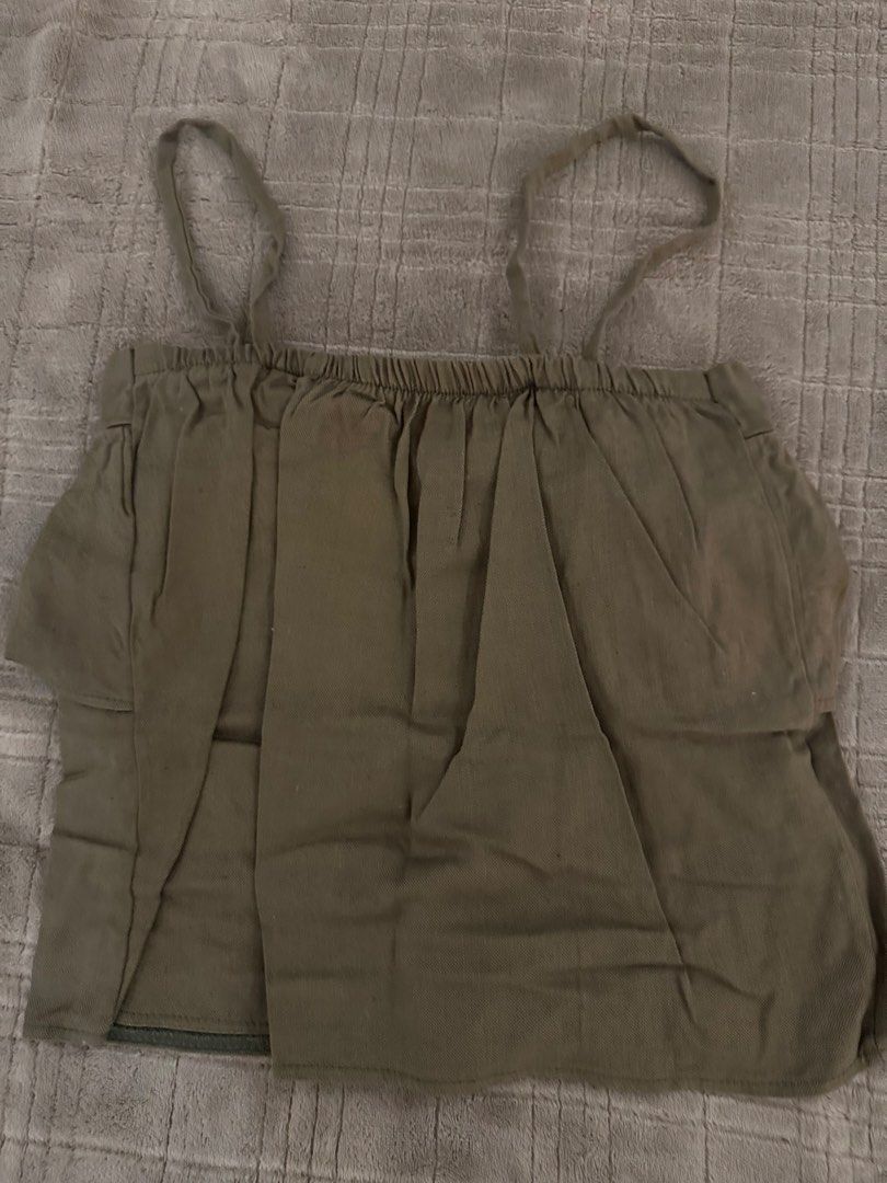 Green Cami Top Ruffle Layer Tank (Category: Sleeveless) located in Manila. Submitted by cabuniagpr58494 (Listing ID 1470077031, Image 2). Description: - Color: Neutral olive green - Design: Gathered elastic neckline with a pleated front ruffle layer - Fit: Relaxed boxy fit - Straps: Thin, adjustable straps with pull-on style - Style: Casual everyday wear, easy to match with denim shorts or skirts.