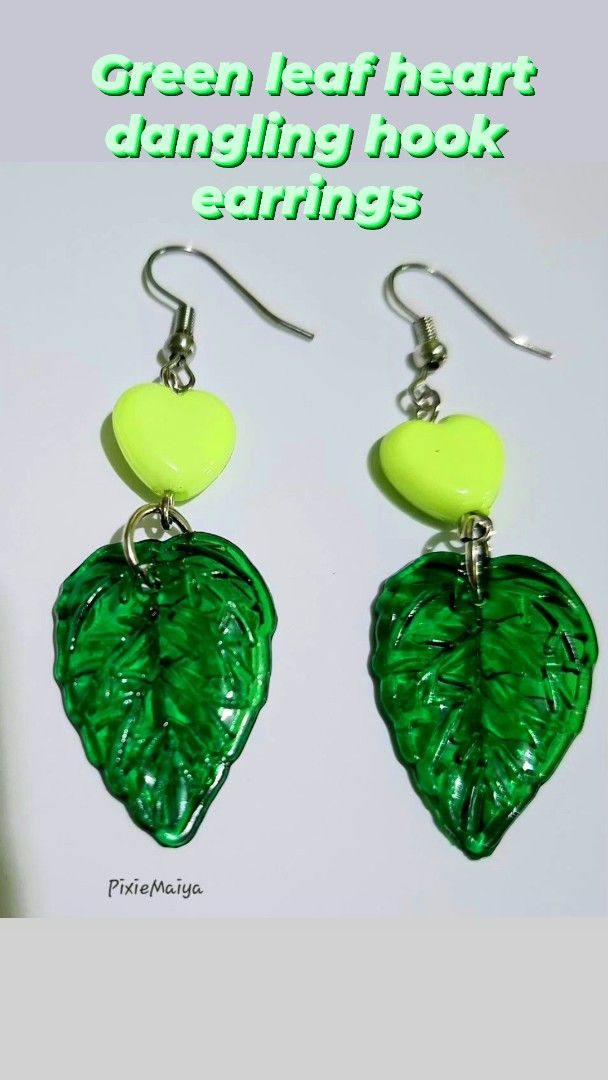 Green leaf heart dangling hook earrings and beaded necklace (Category: Earrings) located in Valenzuela. Submitted by pixieworks64309 (Listing ID 1469949833, Image 3). Description: - Handmade jewelry set including dangling hook earrings and a matching beaded necklace - Features green translucent leaf charms and bright lime green heart beads - Chain designed with alternating bugle and seed beads in various shades of green - Equipped with secure hoo