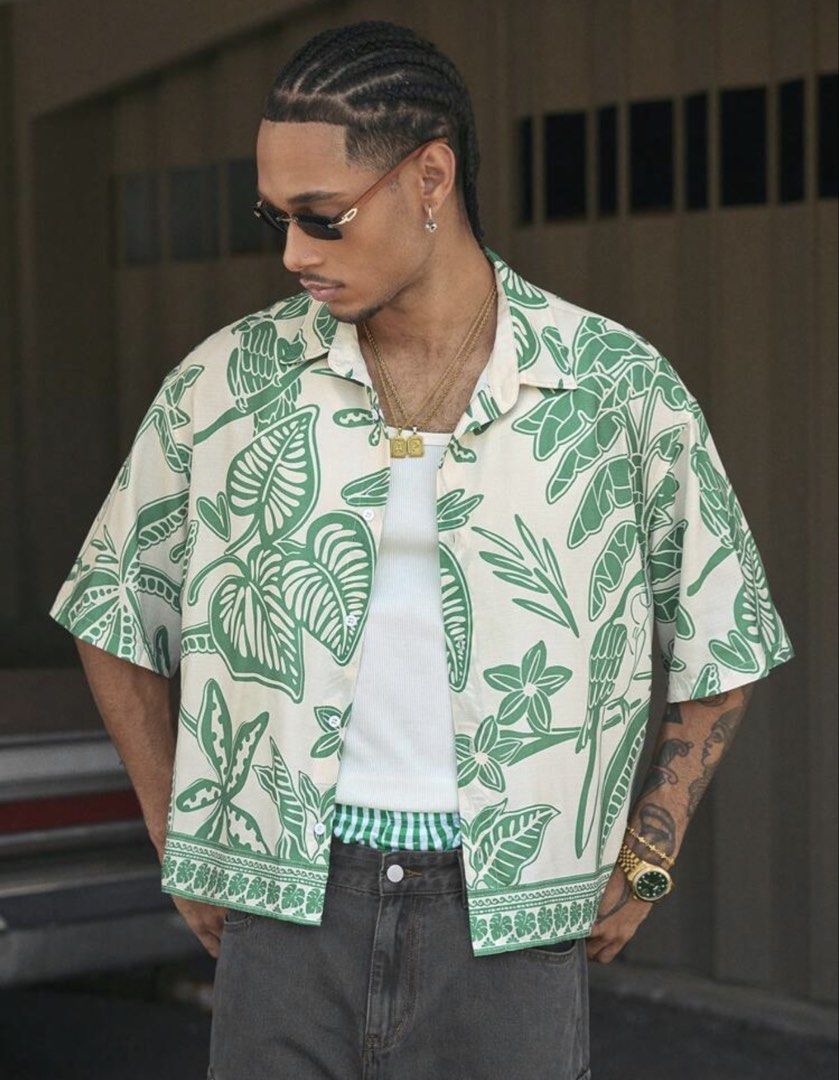 Tropical Cropped Polo (Category: Tshirts & Polo Shirts ) located in Las Pinas. Submitted by rareriroruru (Listing ID 1470052049, Image 3). Description: - Style: Relaxed resort-style short sleeve button-up - Print: Tropical parrot and jungle leaf all-over print with a patterned hem border - Color: Green and off-white - Size: Small - Length: 23.5 in - Width: 24 in - Material: Lightweight and breathable fabric - Ideal for: Summer, beach trips, and c