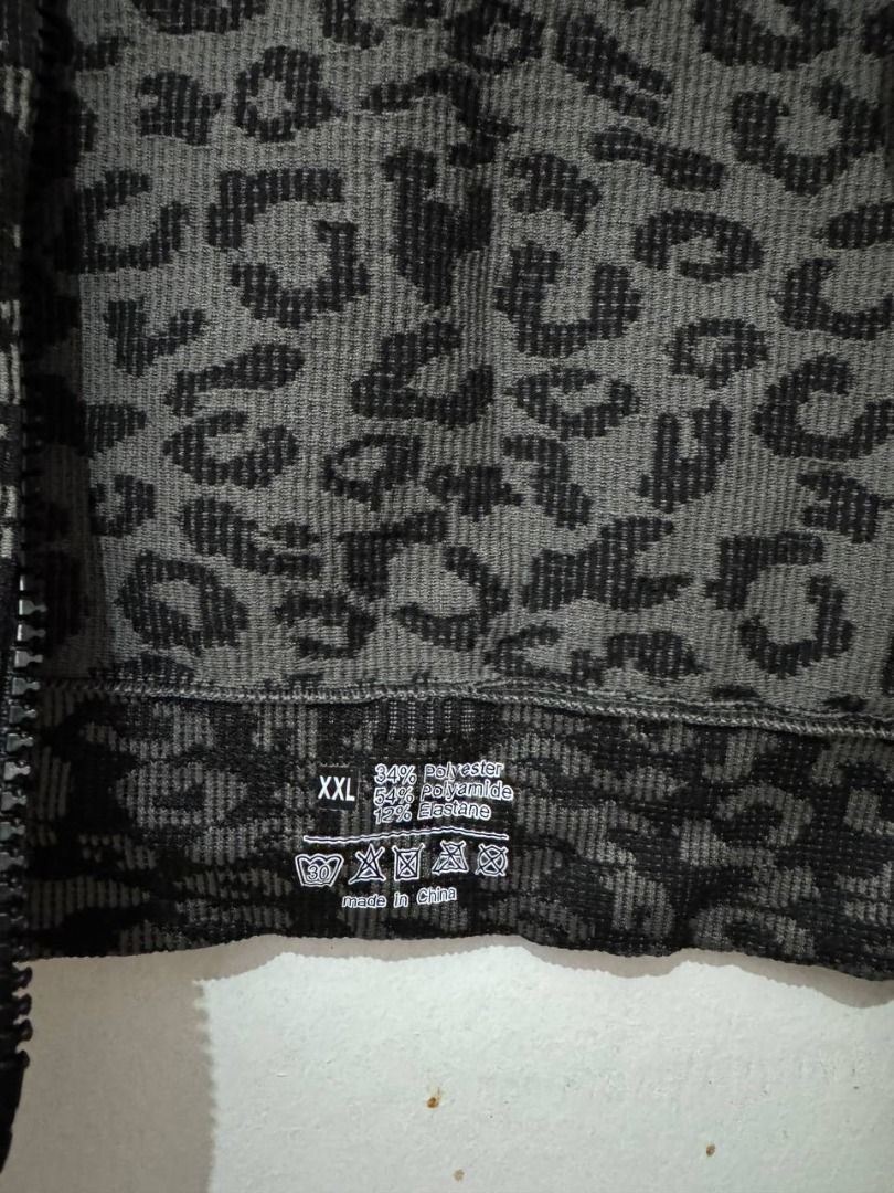 Grey Leopard Print Activewear Zip Jacket (Category: Coats, Jackets and Outerwear) located in Santa Rosa. Submitted by sherikasstuff (Listing ID 1469958313, Image 3). Description: - Style: Grey and black animal print athletic jacket - Size: XXL but can fit XS-S - Design: Full zip front with a round collar - Features: Long sleeves with convenient thumb holes at the cuffs - Material: Comfortable ribbed knit blend (54% polyamide, 34% polyester, 12% e