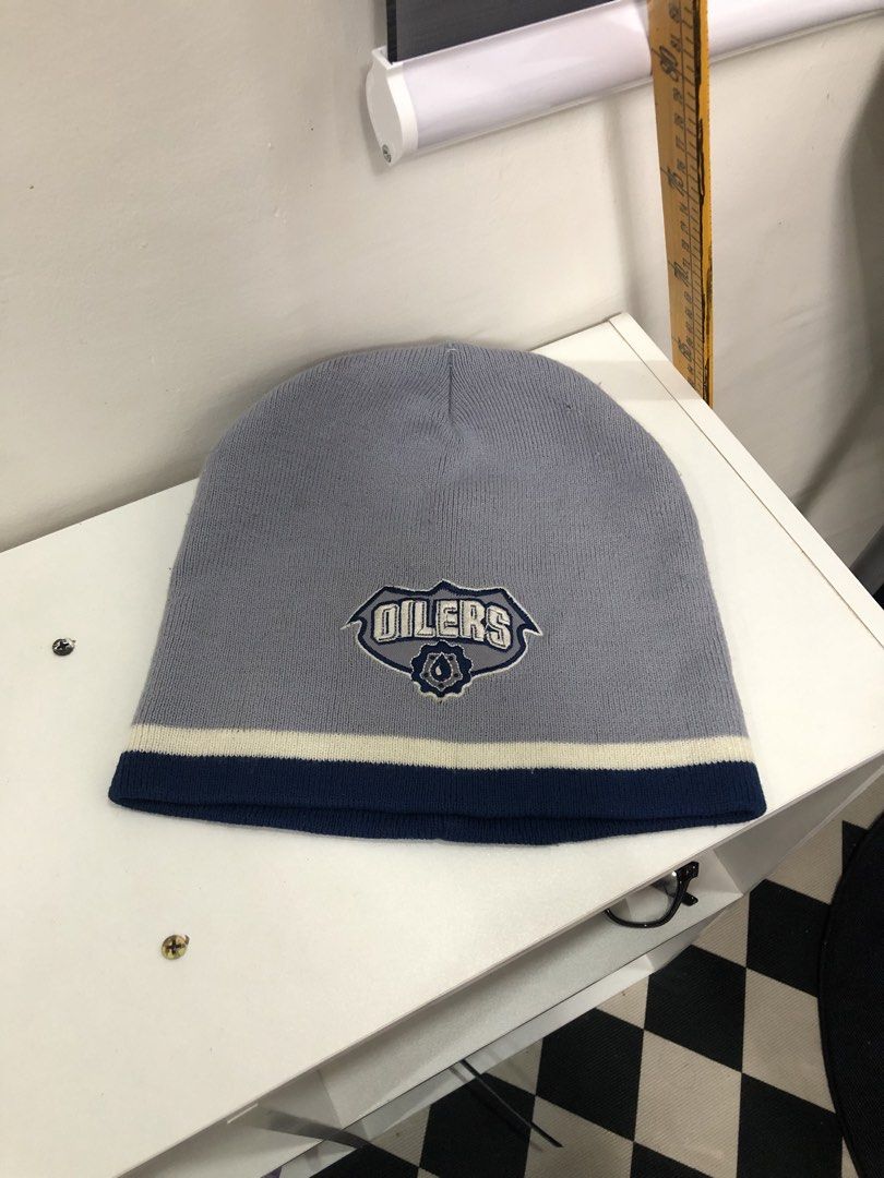 Grey Oilers Beanie (Category: Caps & Hats) located in Manila. Submitted by ejaay_2012 (Listing ID 1470103568, Image 1). Description: - Official NHL merchandise featuring embroidered Edmonton Oilers logo - Stylish grey design with navy blue and white stripes - Made with soft 100% acrylic knit material for maximum comfort - Keeps you warm during game days or cold weather - Brand new with tags attached.