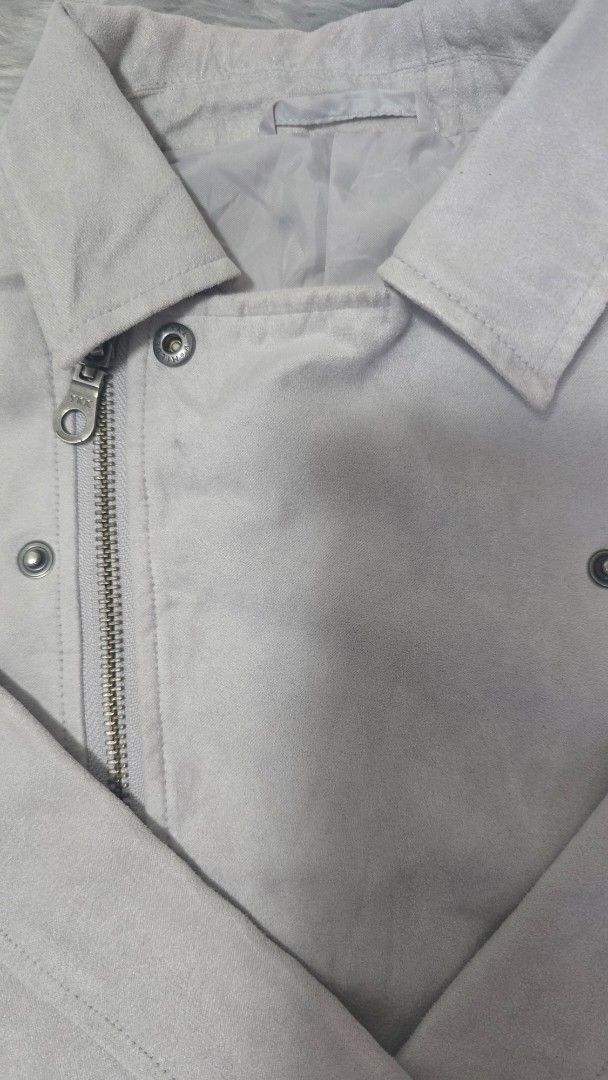 GU Grey Suede Jacket Size 110 (Category: Coats, Jackets and Outerwear) located in Cabanatuan. Submitted by belle_1013 (Listing ID 1470027560, Image 3). Description: - Brand: GU - Item: Suede jacket - Color: Grey - Size: 110 - Material: 100% polyester (outer and lining) - Closure: Front zipper with collar and snap buttons - Condition: Clean with interior tags intact - Perfect layering piece for cooler weather.