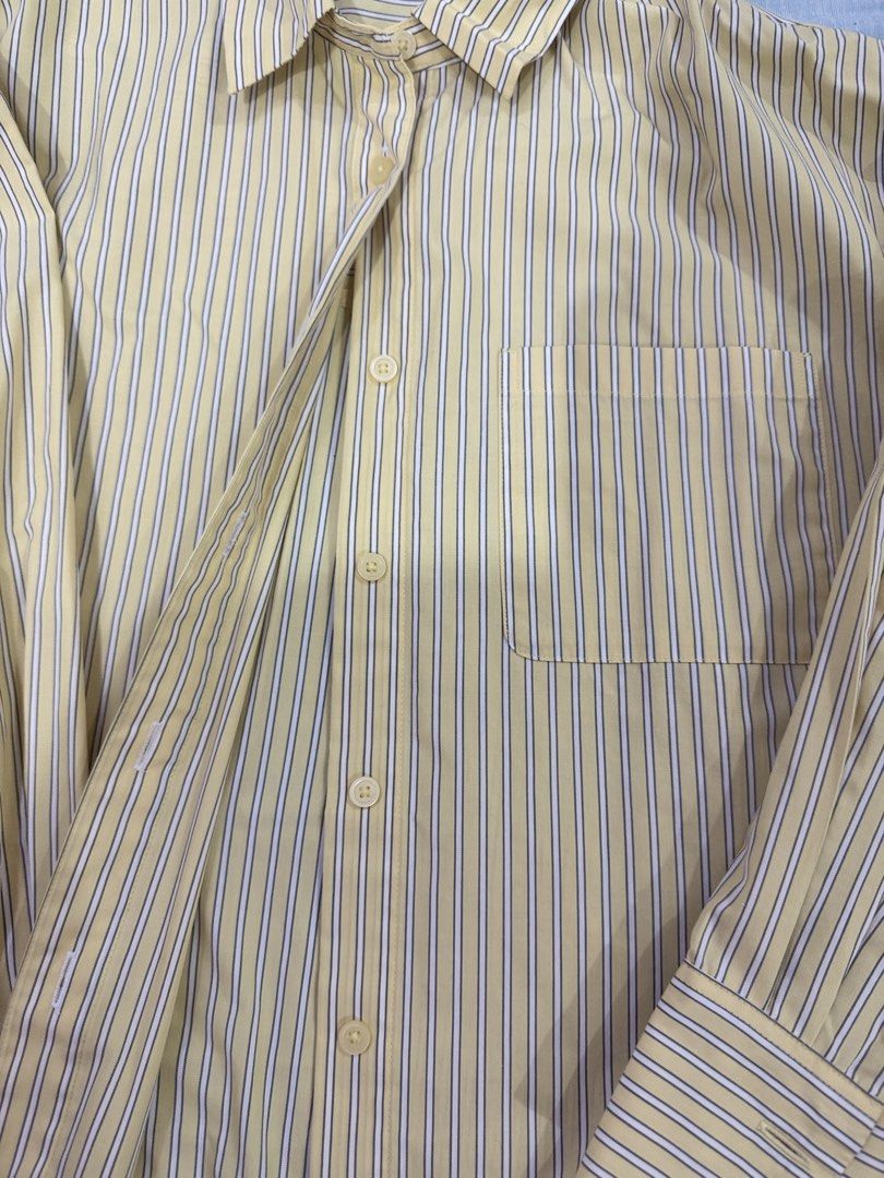GU Yellow Striped Long Sleeve Button-Down Shirt | M (Category: Longsleeves) located in Manila. Submitted by buymiclothes.47 (Listing ID 1470105645, Image 3). Description: GU Yellow Striped Long Sleeve Button-Down Shirt | M Cute pale yellow striped button-down shirt from GU 💛 * Brand: GU (Uniqlo sister brand) * Size: Medium * Color: Pale yellow with navy and white stripes * Long sleeves with buttoned cuffs * Collared neckline * Front button closu