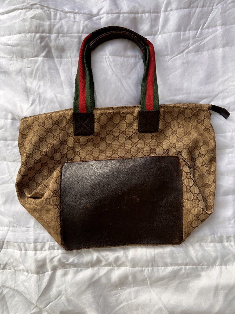 Gucci GG Monogram Web Stripe Tote Bag (Category: Luxury Bags & Wallets) located in Manila. Submitted by mightylion-ce6ea7 (Listing ID 1470032246, Image 2). Description: - Gucci tote bag with classic GG monogram canvas - Features premium brown leather trim and base - Signature red and green web stripe fabric handles - Secure zip closure across the top - Interior leather branding tag included - Condition: Shows visible wear on the handles, edges, a