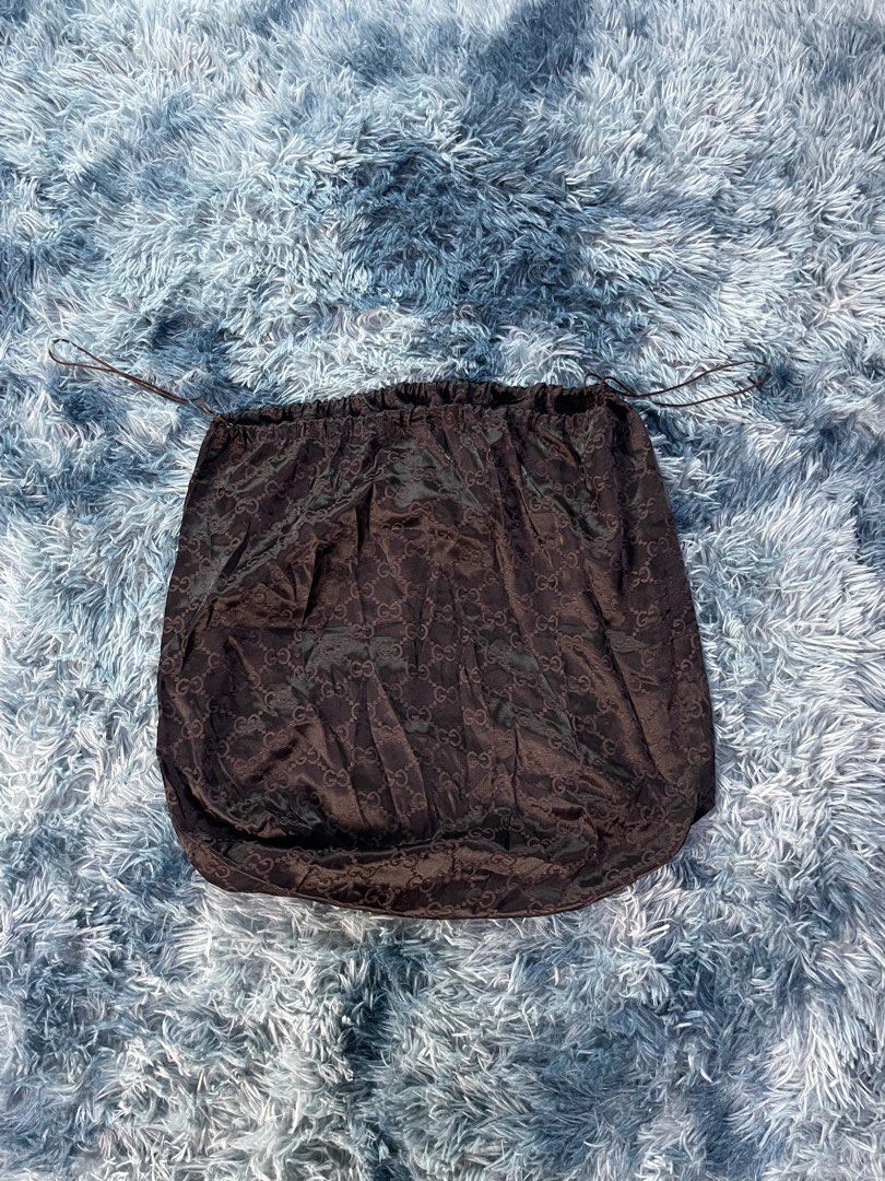 Gucci Monogram Brown Silk Dust Bag Drawstring Pouch (Category: Luxury Bags & Wallets) located in Manila. Submitted by jssur (Listing ID 1470085060, Image 2). Description: - Authentic brown silk Gucci dust bag - Features the iconic allover interlocking G monogram pattern - Smooth and luxurious satin finish fabric - Secure double-cord drawstring closure on both sides - Perfect for protecting designer bags from dust and scratches.