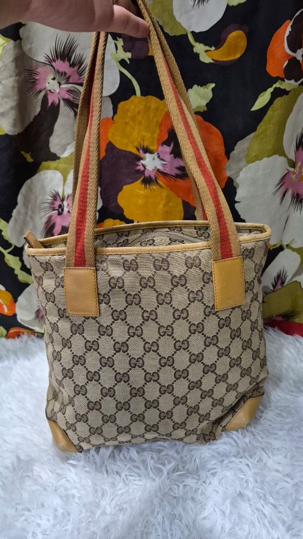 Gucci Monogram Canvas Shoulder Bag (Category: Luxury Bags & Wallets) located in Baguio. Submitted by jhaz_bags (Listing ID 1470101338, Image 1). Description: - Authentic Gucci shoulder bag crafted from signature monogram canvas - Features stylish brown leather trim, tan leather panels, and iconic web stripe straps - Secure zip-top closure opening to a dark fabric interior with a convenient zipper pocket - Includes official leather Gucci brand tag