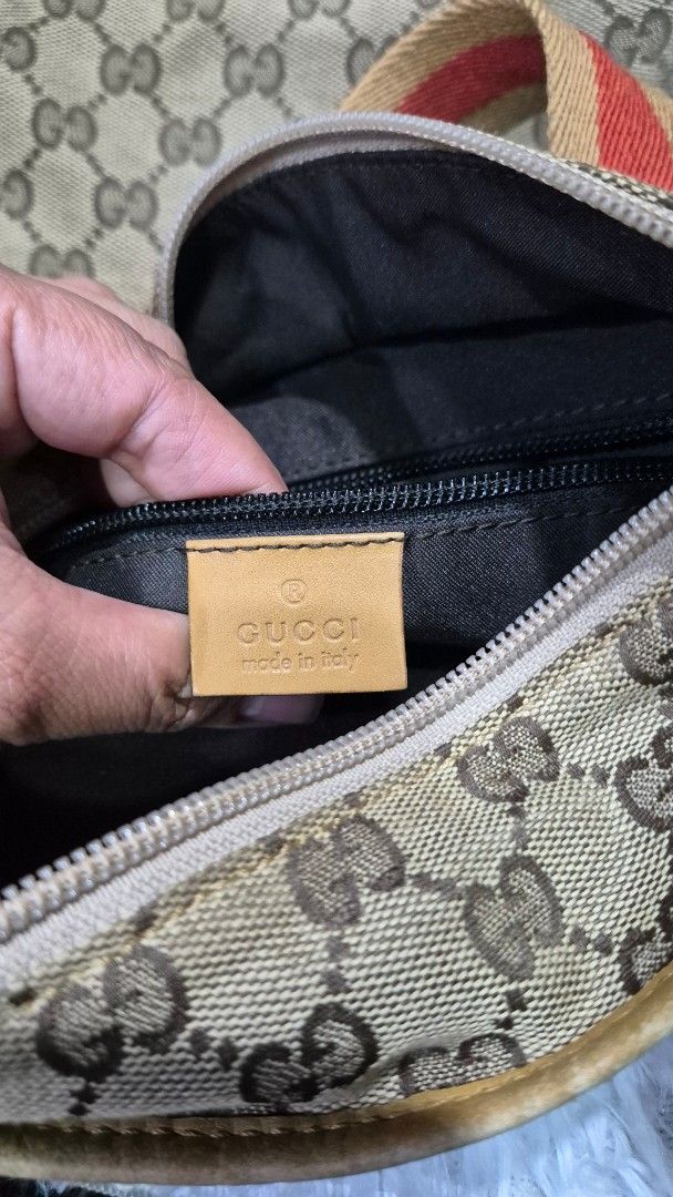 Gucci Monogram Canvas Shoulder Bag (Category: Luxury Bags & Wallets) located in Baguio. Submitted by jhaz_bags (Listing ID 1470101338, Image 2). Description: - Authentic Gucci shoulder bag crafted from signature monogram canvas - Features stylish brown leather trim, tan leather panels, and iconic web stripe straps - Secure zip-top closure opening to a dark fabric interior with a convenient zipper pocket - Includes official leather Gucci brand tag