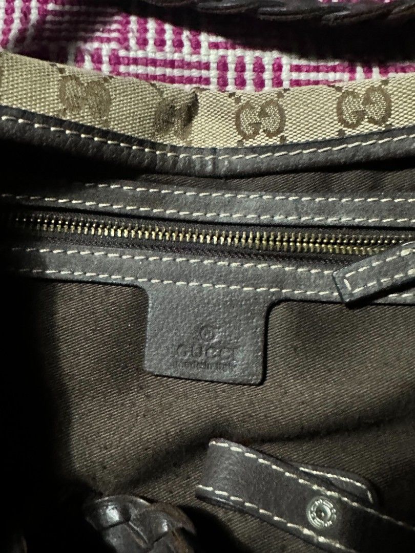 Gucci Monogram Canvas Shoulder Bag with Brown Leather (Category: Luxury Bags & Wallets) located in Manila. Submitted by wardrobeph.com (Listing ID 1470124064, Image 2). Description: - Authentic Gucci shoulder bag with classic GG monogram canvas - Features stylish brown leather trim and comfortable braided straps - Metal hardware details on the front straps - Roomy interior with fabric lining and a convenient zipper pocket - Includes official Gucc