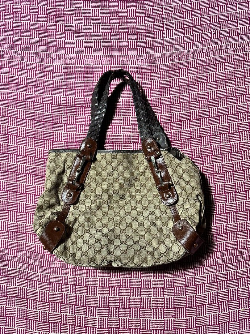 Gucci Monogram Canvas Shoulder Bag with Brown Leather (Category: Luxury Bags & Wallets) located in Manila. Submitted by wardrobeph.com (Listing ID 1470124064, Image 1). Description: - Authentic Gucci shoulder bag with classic GG monogram canvas - Features stylish brown leather trim and comfortable braided straps - Metal hardware details on the front straps - Roomy interior with fabric lining and a convenient zipper pocket - Includes official Gucc