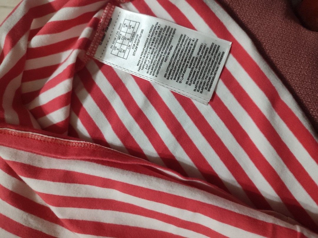 Guess Red and White Striped Top Size S (Category: Blouses) located in Cainta. Submitted by boldhorse_d62227 (Listing ID 1469956047, Image 3). Description: - Brand: Guess authentic - Color/Pattern: Red and white striped - Size: S (tag and care instructions attached) - Material: 95% cotton, 5% spandex (soft, stretchy, and comfortable) - Origin: Made in Peru - Design: Short sleeves, scoop neckline, and sparkly silver sequin lettering across the fron