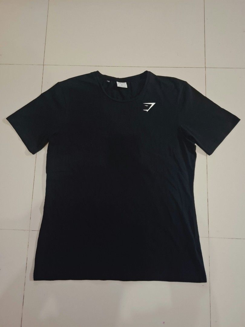 Gymshark black shirt (Category: Activewear) located in Narvacan. Submitted by jigger85 (Listing ID 1470080822, Image 1). Description: gymshark black shirt like new no issue 9.8 condition size: xl on tag dimes: 21 x 28 can fit to medium to large.