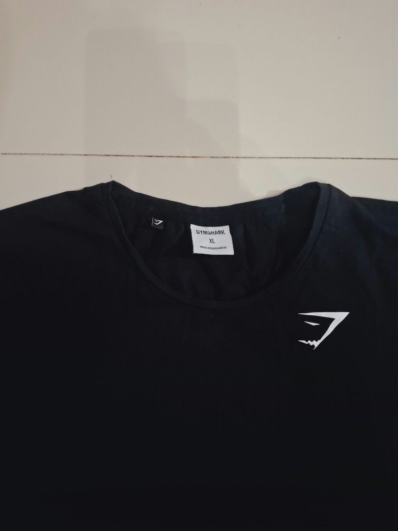 Gymshark black shirt (Category: Activewear) located in Narvacan. Submitted by jigger85 (Listing ID 1470080822, Image 2). Description: gymshark black shirt like new no issue 9.8 condition size: xl on tag dimes: 21 x 28 can fit to medium to large.