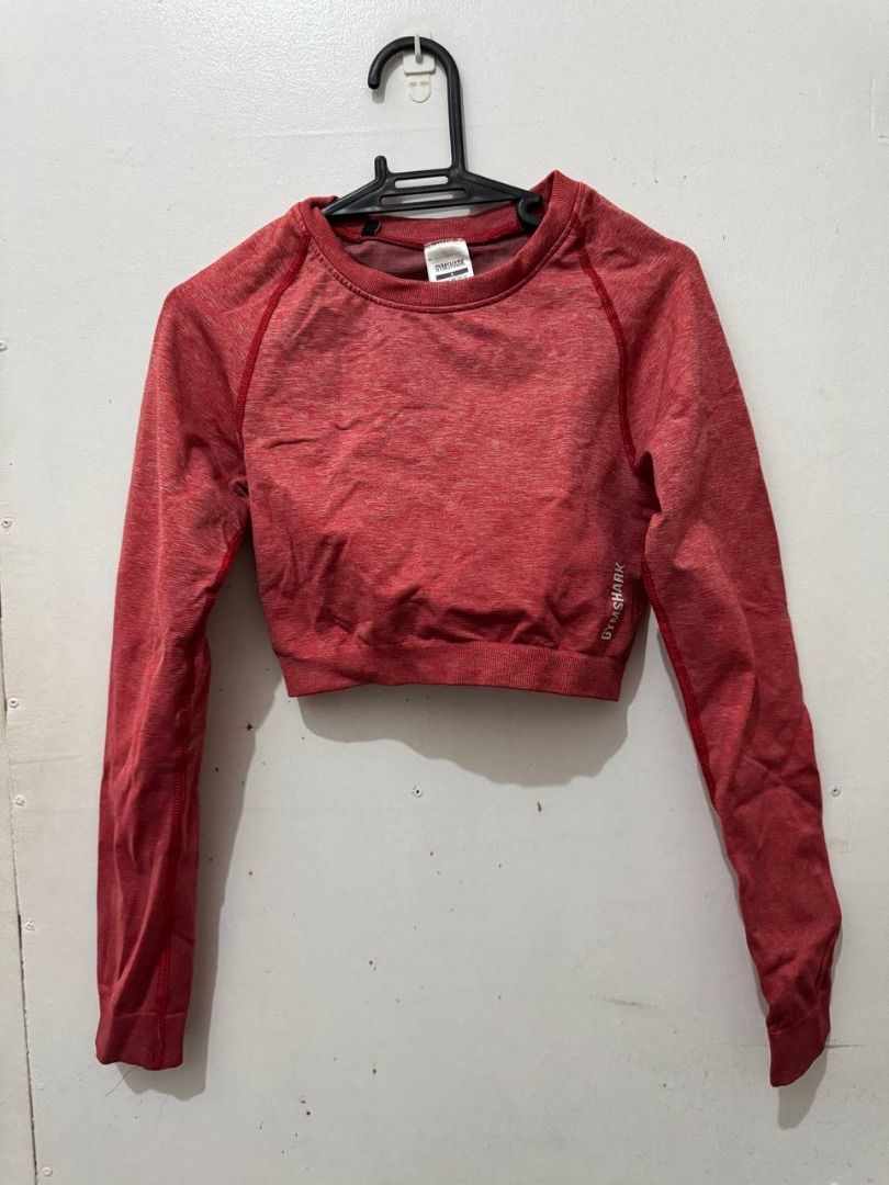 Gymshark Red Marled Long Sleeve Crop Top (Category: Longsleeves) located in Santa Rosa. Submitted by sherikasstuff (Listing ID 1469957740, Image 1). Description: - Color/Fabric: Reddish pink marled - Condition: Used only once/Excelllent - Size: S but can fit XS-S - Material: 64% polyamide, 29% polyester, 7% elastane - Features: Round neck, raglan sleeves, printed white logo near hem - Perfect for: Workout sessions, gym, aerial silk/hammock/hoop, 