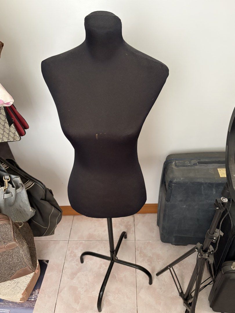 Half Body Mannequin with Stand (Category: Dresses) located in Caloocan City. Submitted by mon_cheeri (Listing ID 1469996780, Image 3). Description: - Color: All-black design with stretchy fabric cover - Stand: Stable 3-legged black metal base with adjustable height pole - Multi-purpose: Ideal for clothing displays, sewing projects, and photography setups - Condition: Pre-owned with minor damage and discoloration stains on the front chest area RFS