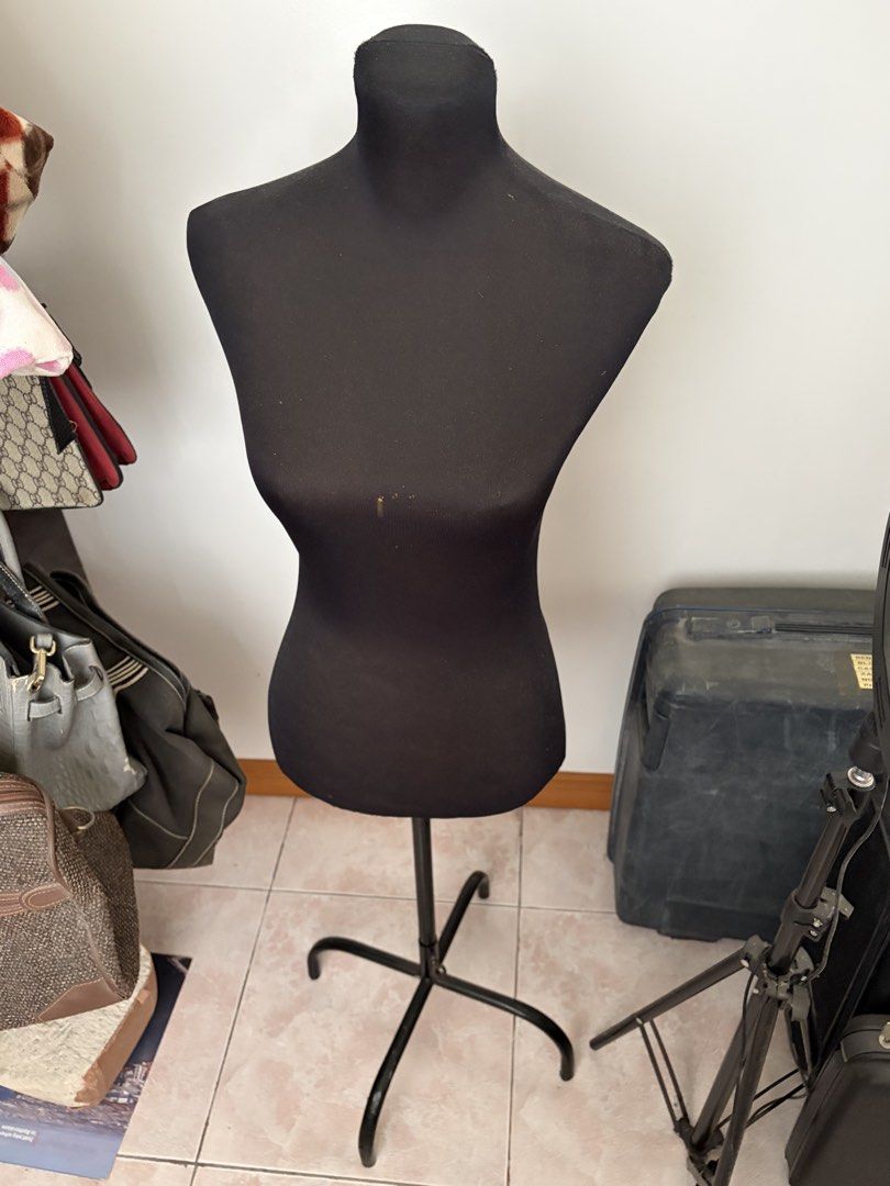 Half Body Mannequin with Stand (Category: Dresses) located in Caloocan City. Submitted by mon_cheeri (Listing ID 1469996780, Image 2). Description: - Color: All-black design with stretchy fabric cover - Stand: Stable 3-legged black metal base with adjustable height pole - Multi-purpose: Ideal for clothing displays, sewing projects, and photography setups - Condition: Pre-owned with minor damage and discoloration stains on the front chest area RFS