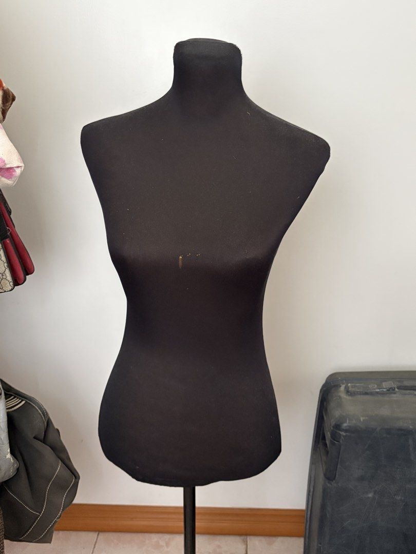 Half Body Mannequin with Stand (Category: Dresses) located in Caloocan City. Submitted by mon_cheeri (Listing ID 1469996780, Image 1). Description: - Color: All-black design with stretchy fabric cover - Stand: Stable 3-legged black metal base with adjustable height pole - Multi-purpose: Ideal for clothing displays, sewing projects, and photography setups - Condition: Pre-owned with minor damage and discoloration stains on the front chest area RFS