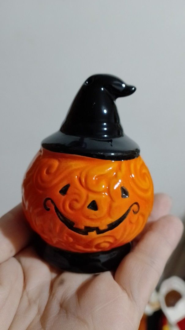 Halloween Pumpkin with Witch Hat Salt and Pepper Shaker (Category: Pitchers & Dispensers) located in San Pablo. Submitted by elijasam (Listing ID 1470132536, Image 1). Description: - Adorable ceramic pumpkin shaker wearing a classic black witch hat - Beautiful textured swirl pattern on the vibrant orange body - Hand-painted smiling jack-o-lantern face on the front - Functional dispensing holes neatly placed at the top of the hat - Comes with a se