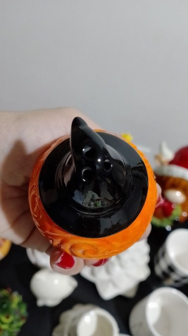 Halloween Pumpkin with Witch Hat Salt and Pepper Shaker (Category: Pitchers & Dispensers) located in San Pablo. Submitted by elijasam (Listing ID 1470132536, Image 3). Description: - Adorable ceramic pumpkin shaker wearing a classic black witch hat - Beautiful textured swirl pattern on the vibrant orange body - Hand-painted smiling jack-o-lantern face on the front - Functional dispensing holes neatly placed at the top of the hat - Comes with a se