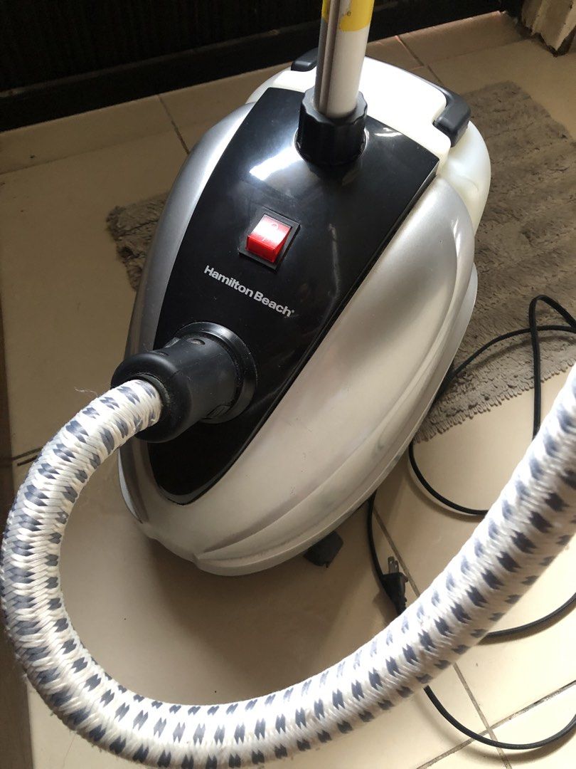 Hamilton Beach Garment Steamer (Category: Irons & Steamers) located in Cavite. Submitted by mayinyerg (Listing ID 1470120077, Image 2). Description: - Brand: Hamilton Beach - Color: Silver and Black - Design: Standing model with adjustable pole and flexible steam hose - Water Tank: Removable with a built-in handle for easy refilling - Condition: Fully working, excellent shape - Inclusions: Original user manual and unused accessory attachments in 
