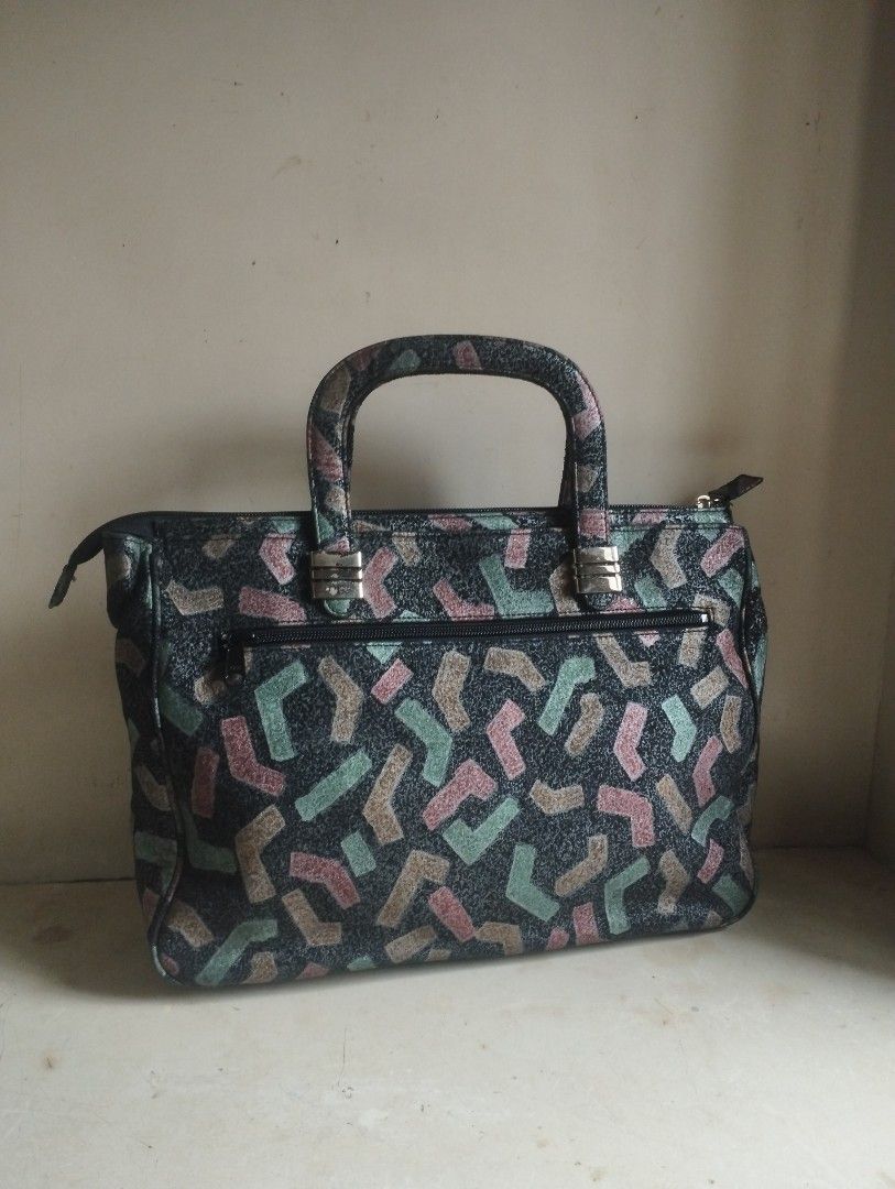 Women handbag (Category: Tote Bags) located in Tagaytay City. Submitted by jagsassortedph (Listing ID 1470021959, Image 3). Description: - SIZE: 13 × 4 × 10 inch - NEGOTIABLE PRICE -Dark handbag with a stylish multi-colored geometric pattern - Dual top handles and sleek silver-tone hardware - Secure top zipper closure for the main compartment - Convenient exterior zippered pocket on the back - Structured rectangular shape with a flat base and roo
