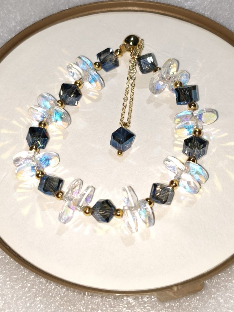 Handmade Beaded Charm Bracelets with Adjustable Chains (Category: Bracelets) located in Caloocan City. Submitted by books_and_beads (Listing ID 1470083277, Image 2). Description: - Handmade beaded bracelets - Features pastel flower beads, iridescent crystals, dark grey cubes, and light blue faceted stones: · Top Left (Grey Pearl Chain): An elegant, classic design featuring a double strand of clear, twisted glass beads with a row of metallic grey 
