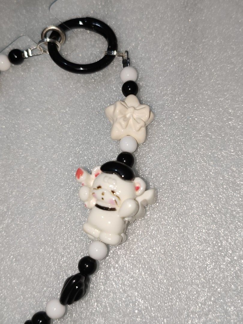 Handmade Black and White Y2K Beaded Keychain (Category: Charms) located in Caloocan City. Submitted by books_and_beads (Listing ID 1470093147, Image 3). Description: - monochrome strap features adorable white kitty figures (one with a little black bow and star, the other with a black hat) mixed with sleek black and white beads. It includes a 'mim' button, a white bow, and a fun textured dalmatian-style bead at the bottom. Perfect for the Y2K or g