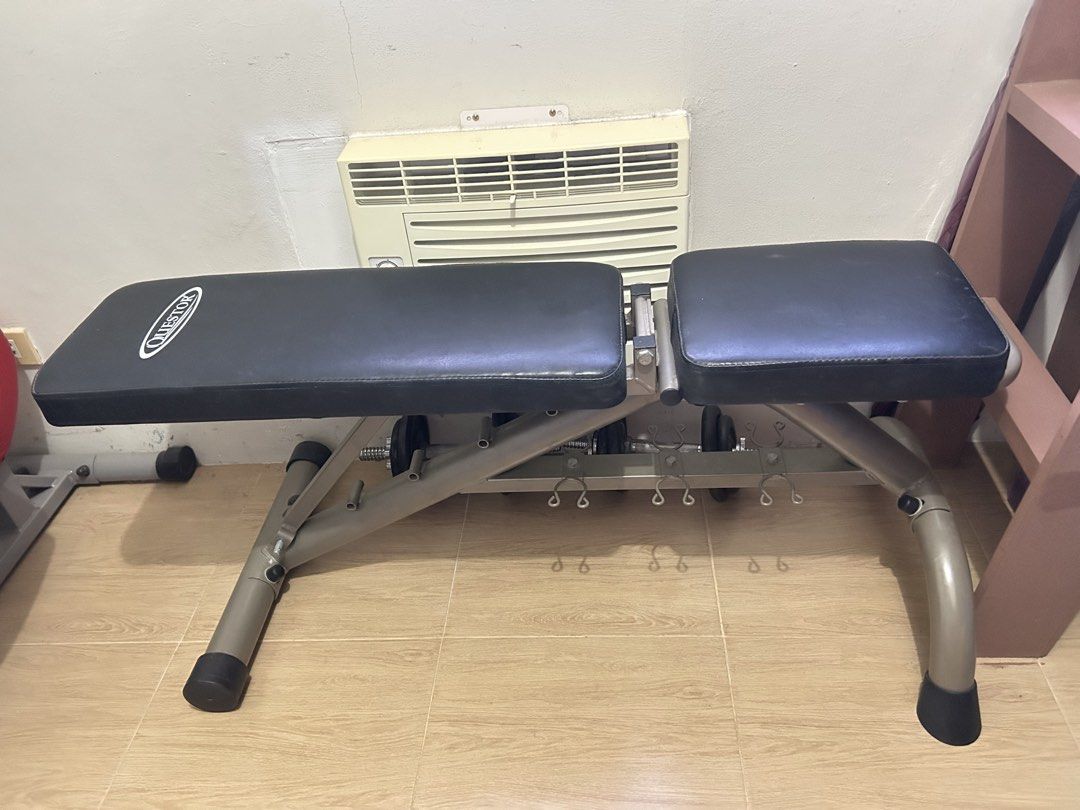 Hard Core Elliptical Bike & Workout Bench (Category: Cardio & Fitness Machines) located in Manila. Submitted by hanjuku (Listing ID 1470046674, Image 2). Description: - Hard Core exercise machine: black and red housing, textured foot pedals, adjustable resistance knob, vertical handlebars - Questor adjustable weight bench: black padded cushions, grey steel frame, convenient dumbbell storage racks underneath - Condition: Fully functional with mino