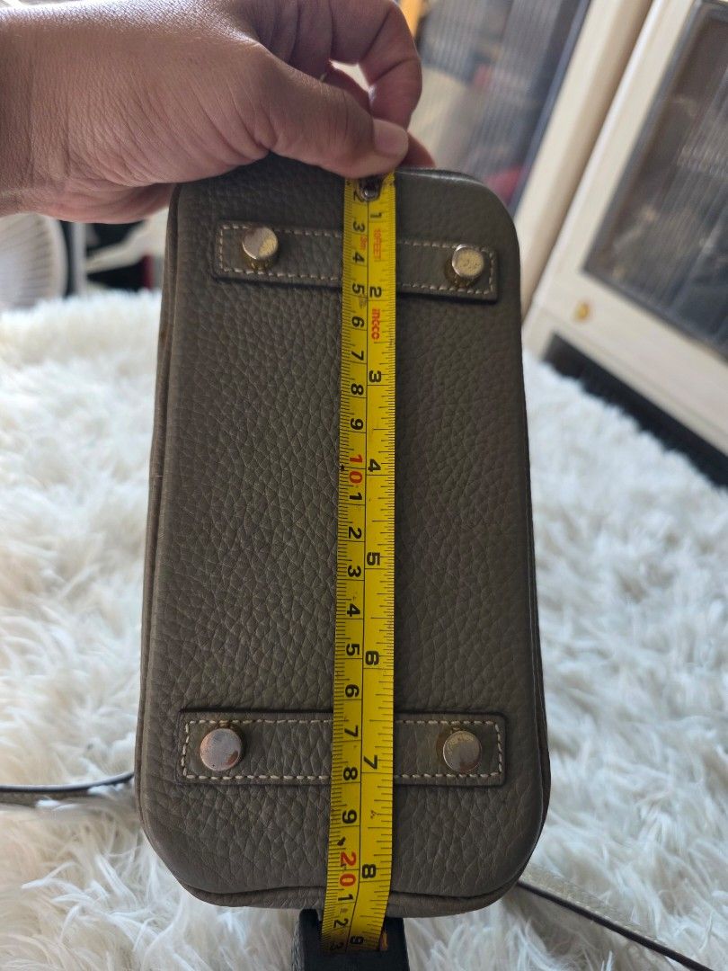Hermès Birkin Handbag Grey (Category: Cross-body Bags) located in Lemery. Submitted by venus23 (Listing ID 1470139326, Image 3). Description: - Style: Hermès Birkin Handbag - Material: Premium grey pebbled leather -Zipper: Riri underzip - Hardware: Elegant gold-tone with classic front flap and turn-lock closure - Size: Approx. 20cm across the bottom base - Features: Double top handles, detachable long crossbody strap, and 4 protective metal feet 