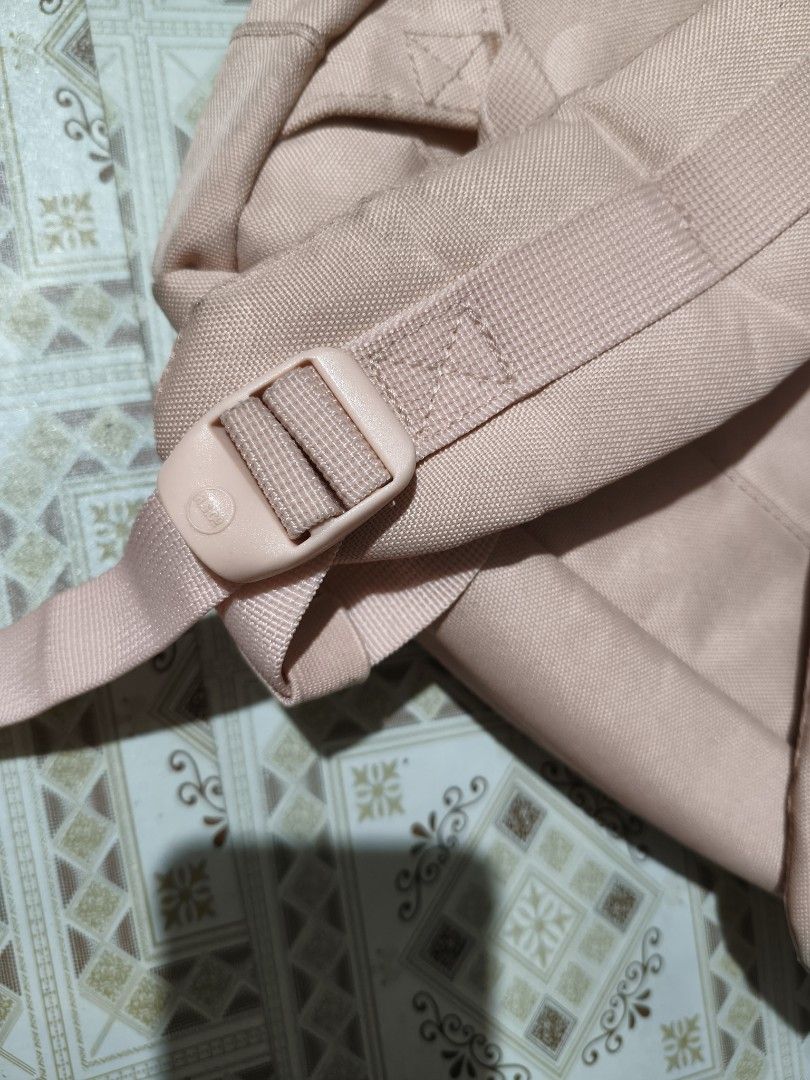 Herschel Supply Co. Pink Backpack (Category: Backpacks) located in Quezon City. Submitted by affordable1 (Listing ID 1470060241, Image 3). Description: Herschel backpack in light pink. Durable canvas material with faux leather straps and buckle closures. Classic front label patch. Main compartment features signature red and white striped fabric lining. Adjustable shoulder straps with buckle hardware on the back. Clean interior and exterior..
