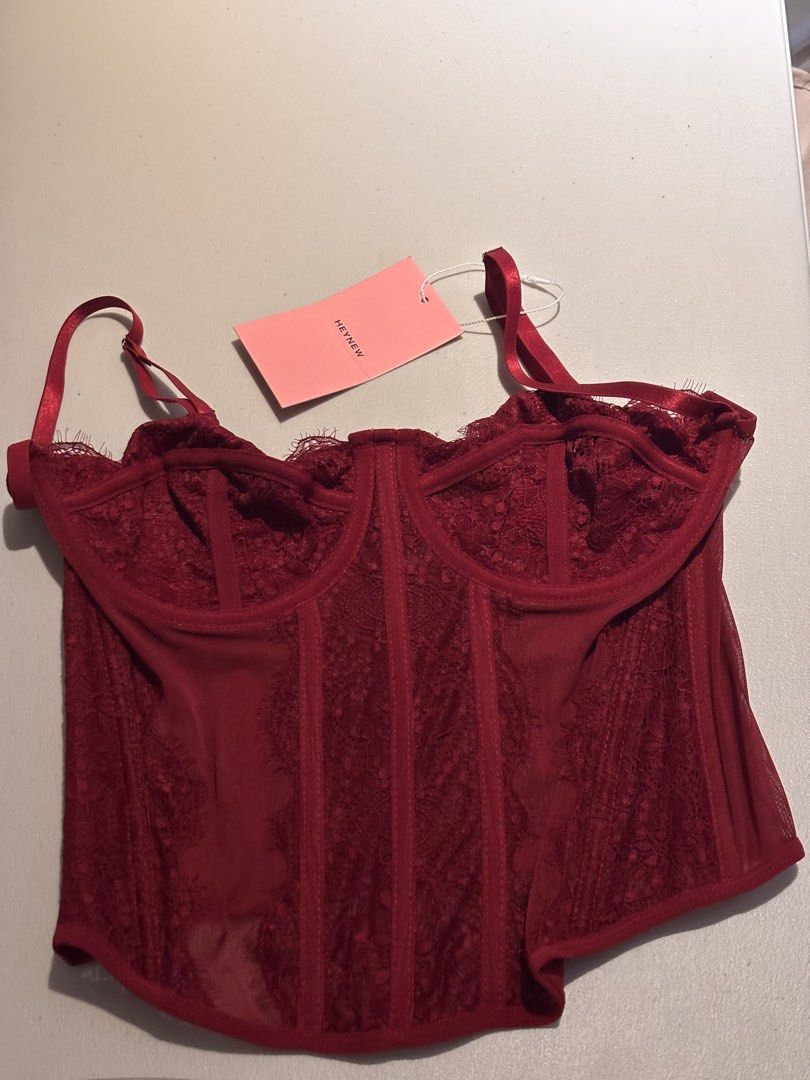 Heynew BKK Red Lace Corset Top (Category: Sleeveless) located in San Pedro. Submitted by lala_leila (Listing ID 1470078209, Image 1). Description: - Brand: Heynew BKK - Condition: Brand new with tags (BNWT) - Color: Burgundy/Maroon/Red - Features: Structured underwire cups, sheer mesh panels, delicate lace overlay - Fit: Adjustable straps with secure back hook-and-eye closure - Style: Versatile piece ideal for stylish layering or night out looks 